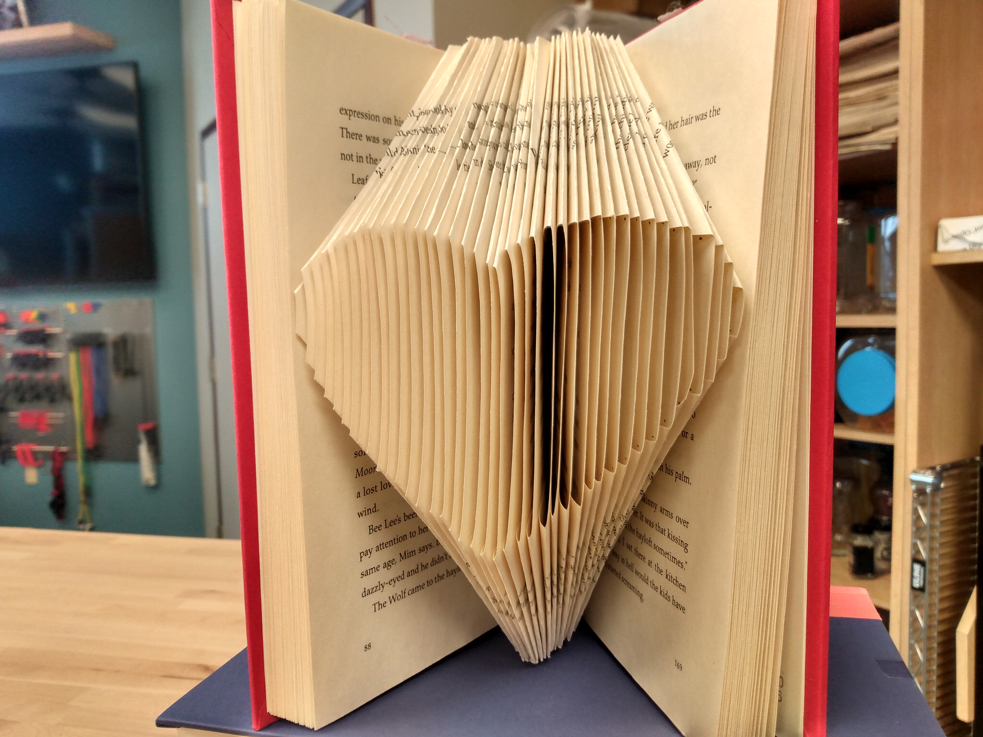 Photo of a book with pages folded in the shape of a heart